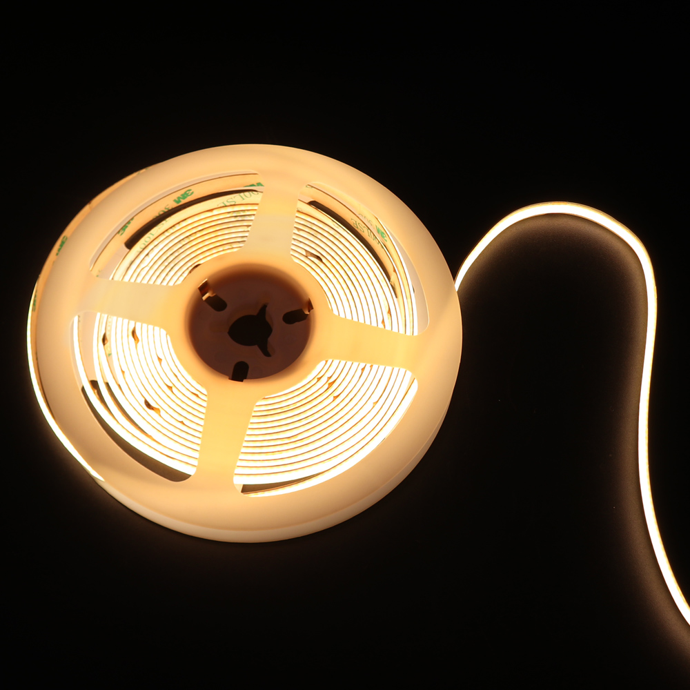 LED strip light on a reel, emitting a soft warm light, ideal for ambient lighting solutions.