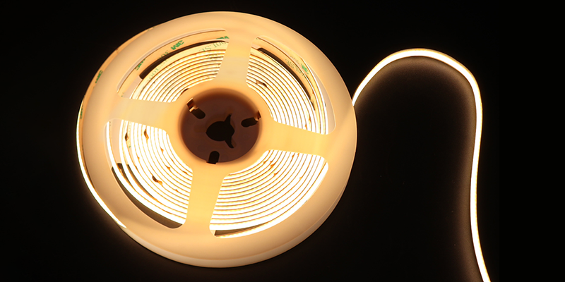 LED strip, coil, lighting LED strip lights coil on a dark background, showing warm white illumination