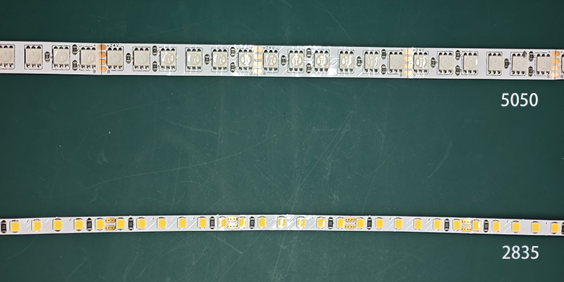 LED comparison, 5050, 2835 Comparison of 5050 and 2835 LED strip lights on a green surface