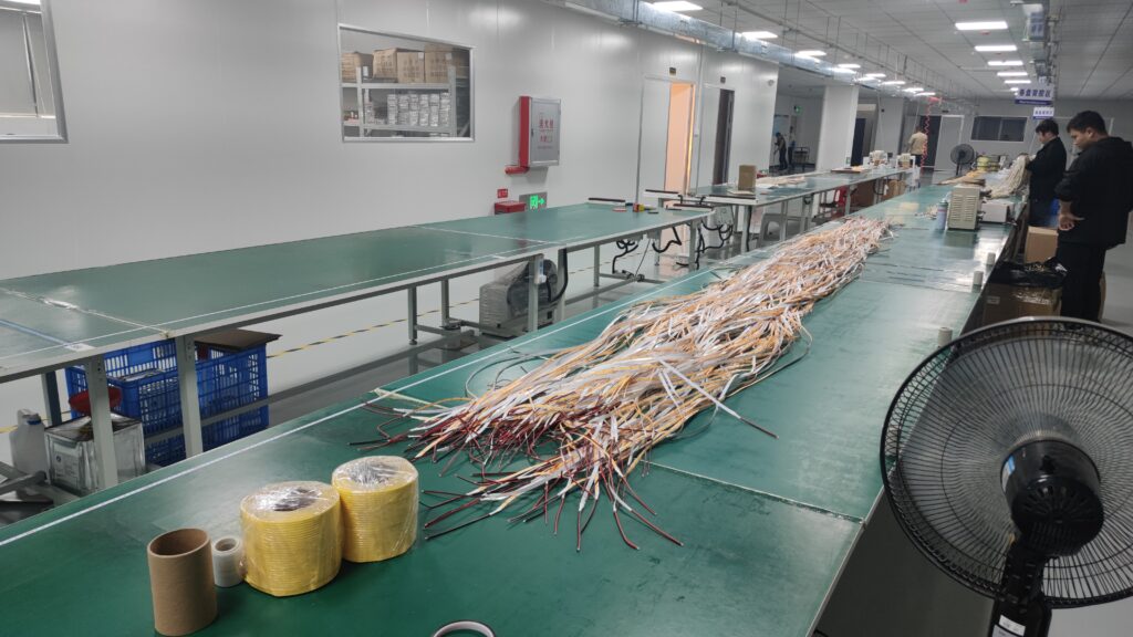 LED strip lights production line in a factory, with assembled strips on the table