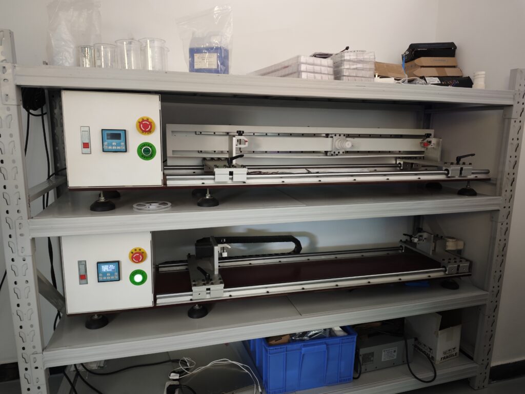 LED strip light processing machines on shelves in a factory workspace