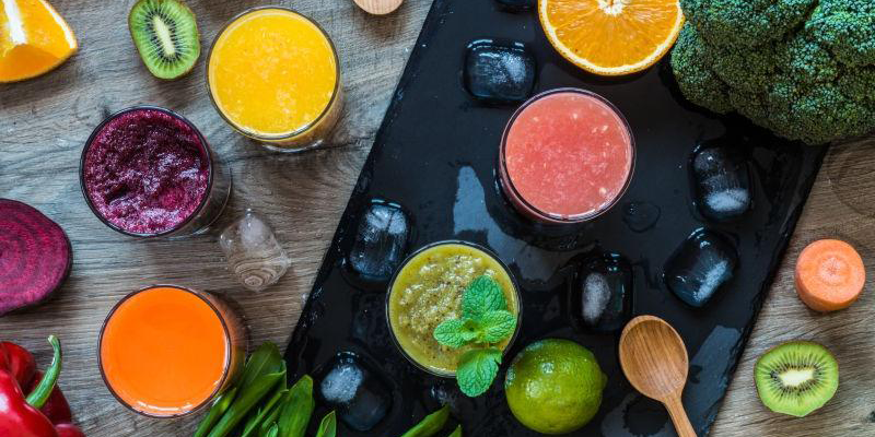 Fresh fruit vegetable juices variety on table