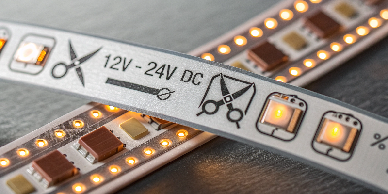 Close-up of cuttable LED strip light with 12V and 24V markings