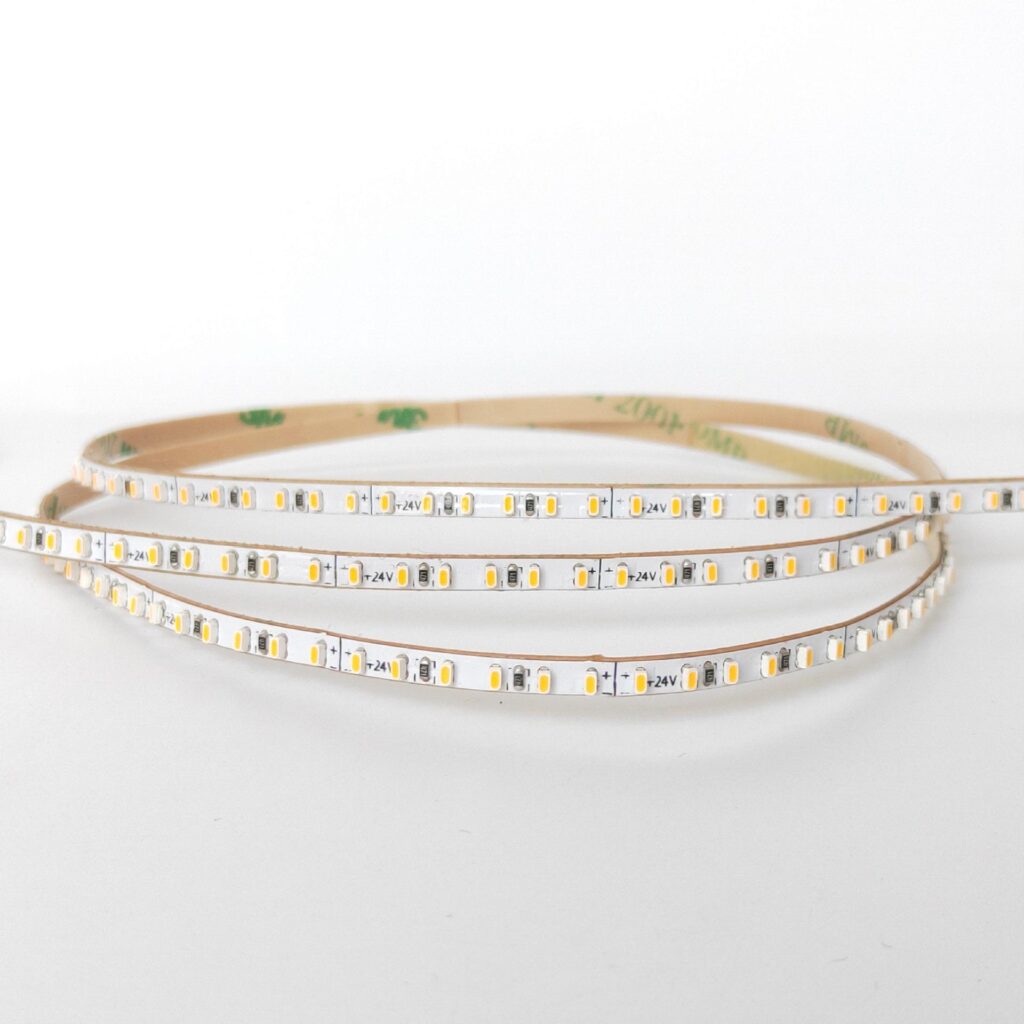 Narrow SMD LED strip light with densely packed 24V LED chips on a flexible white PCB.