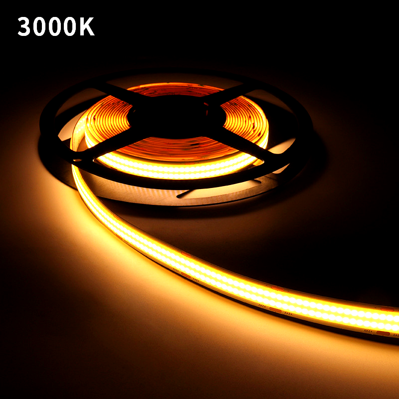 Warm white 3000K COB LED strip light glowing on a reel, showing soft and cozy illumination ideal for indoor ambient lighting
