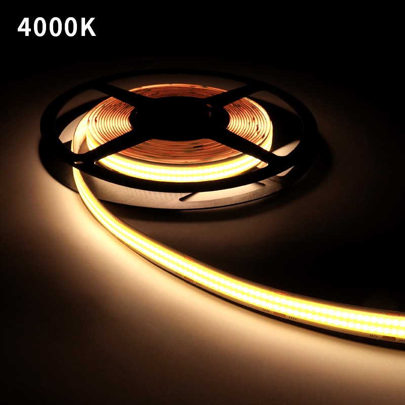 COB LED strip light emitting 4000K natural white light, coiled on a black plastic reel and glowing in a dark environment.