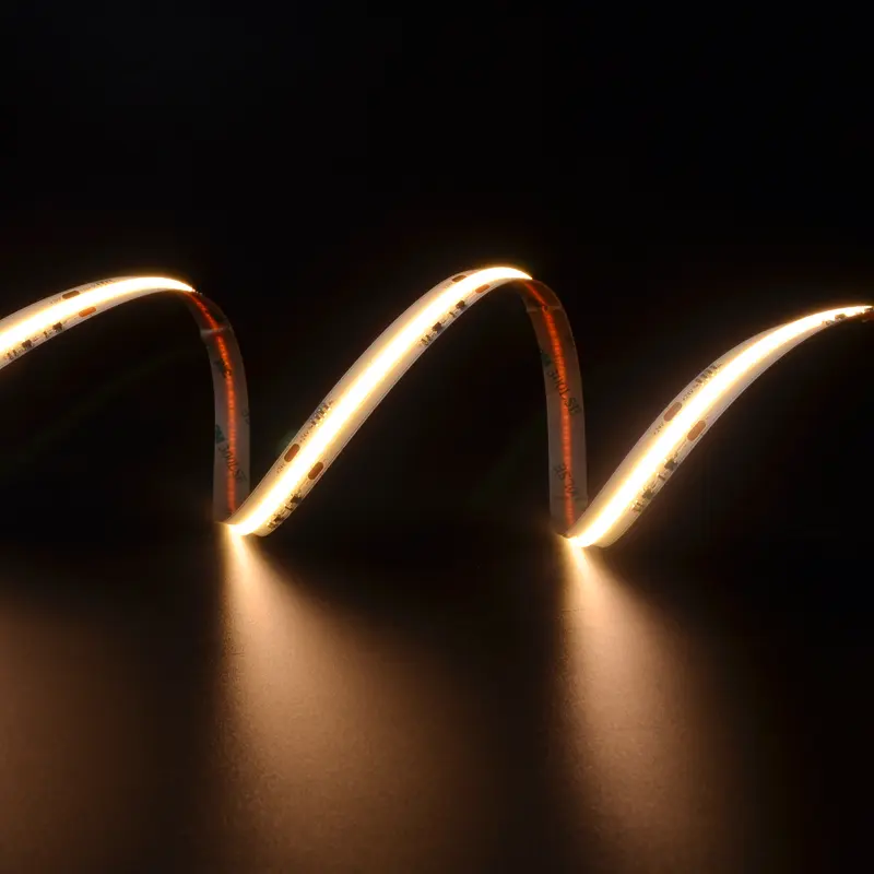 Bendable COB LED strip light emitting a warm glow against a dark background.