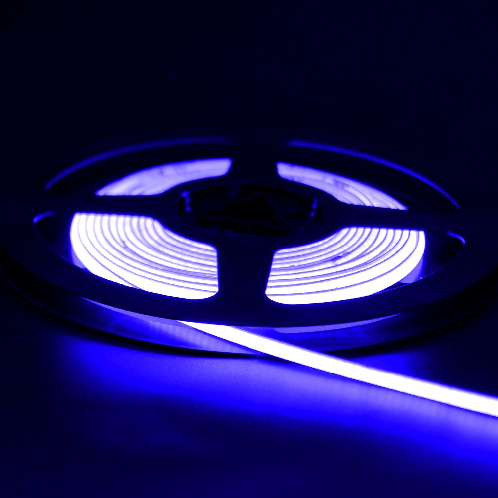 Blue neon flex LED strip light glowing on a reel in a dark setting, showing vibrant illumination and flexible design.