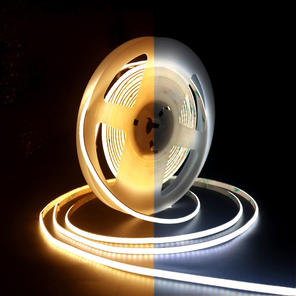 Dual-color temperature COB LED strip light on a reel, showing warm white on the left and cool white on the right, for lighting comparison.