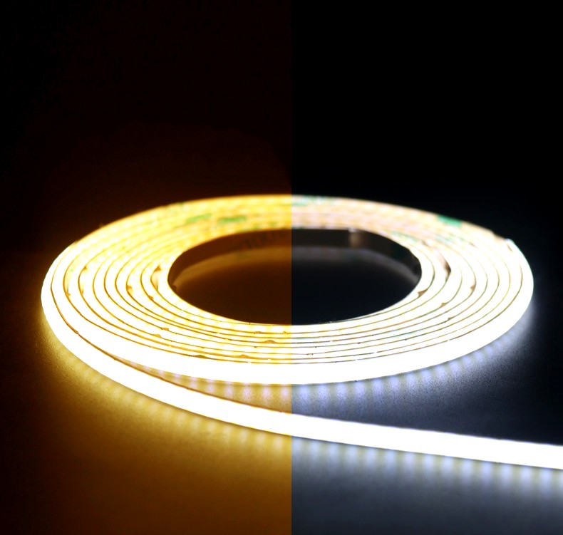 COB LED strip light showing a side-by-side comparison of warm white and cool white color temperatures, coiled neatly on a dark surface.