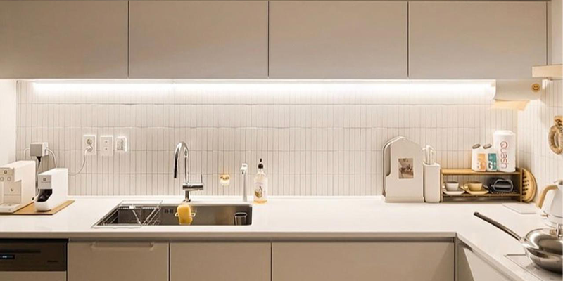 Under cabinet LED strip lighting in minimalist kitchen