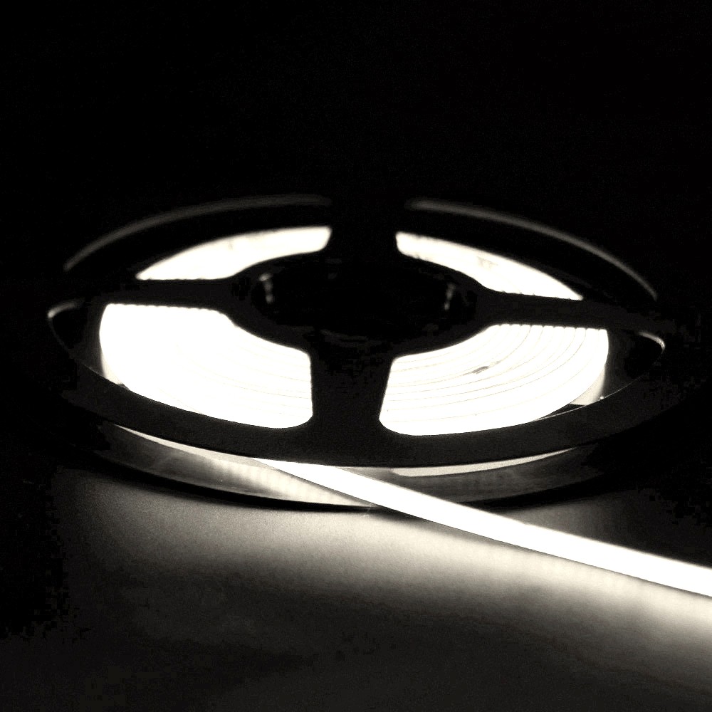 Illuminated white neon LED strip light coiled on a black reel, glowing steadily in a dark environment with soft light reflection.