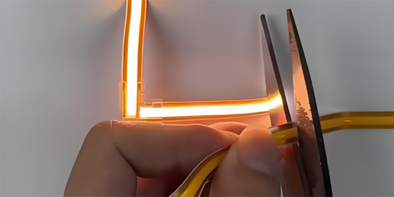 cutting flexible led strip light, corner connector glowing in orange