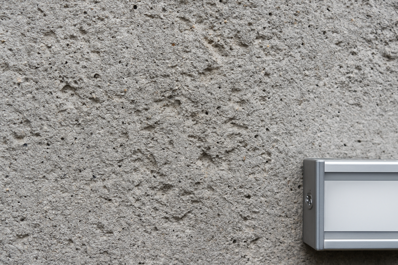 Close-up of Rough, Uneven Concrete Wall Texture Highlighting Mounting Challenges