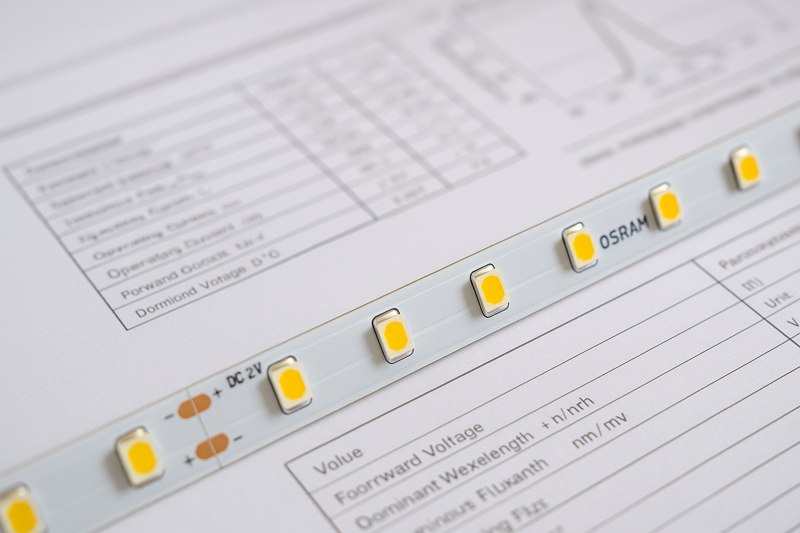 A close-up image of a high-quality LED strip PCB, with clear markings for the brand of the LED chip next to a professional-looking technical datasheet.