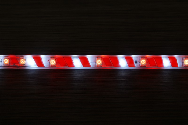 An animated GIF placeholder showing a candy-cane-like red and white chasing pattern moving along an addressable LED strip